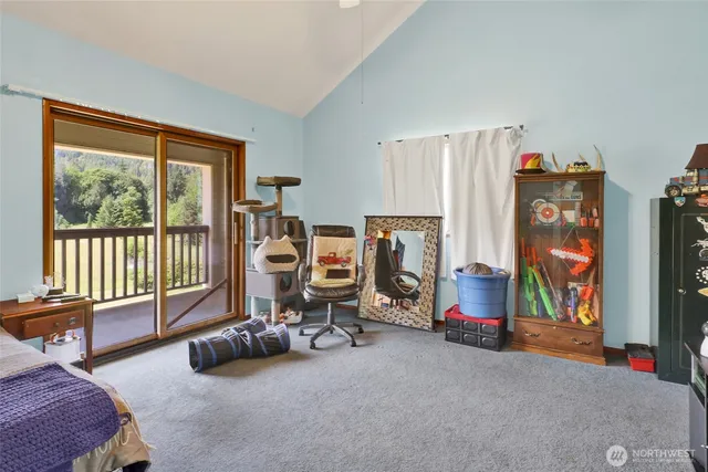 a bedroom with furniture and a large window