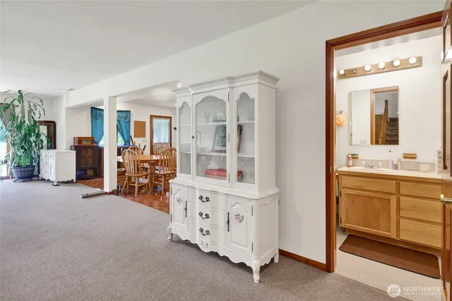 a spacious bedroom with furniture and a large window