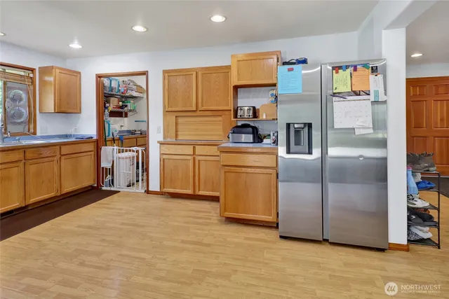 a kitchen with stainless steel appliances a refrigerator and a stove top oven