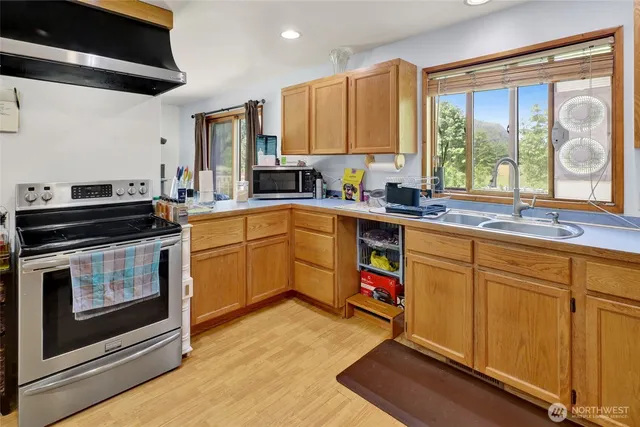 a kitchen with a stove a sink and a microwave