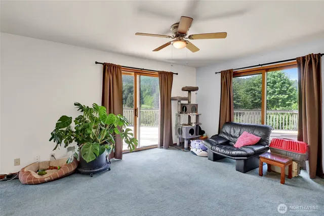 a living room with furniture toys and a large window
