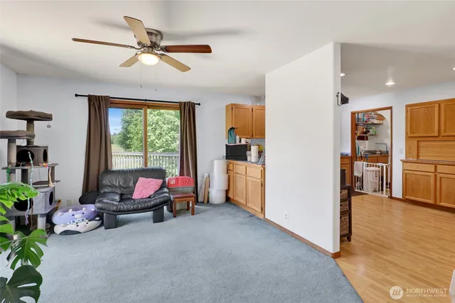 a view of a livingroom with furniture and a ceiling fan