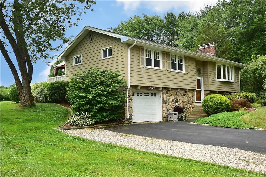 19 School Road Bolton, CT 06043 - Photo 1 of 1 a front view of a house with a yard and garage