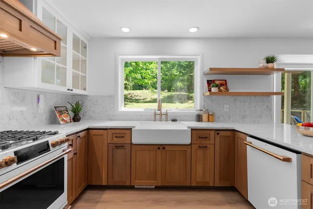 a kitchen with stainless steel appliances a sink stove and cabinets