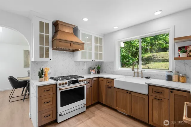 a kitchen with stainless steel appliances a stove sink and cabinets