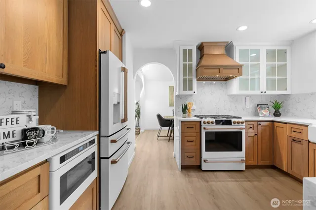 a kitchen with stainless steel appliances a stove a sink and a refrigerator