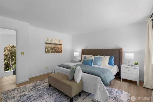 a bedroom with a bed and painting on the wall