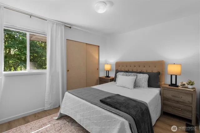 a bedroom with a bed and a chandelier