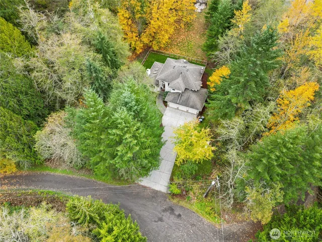 an aerial view of a house with a yard