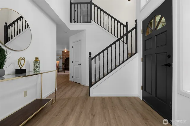 a view of a hallway with wooden floor and entryway
