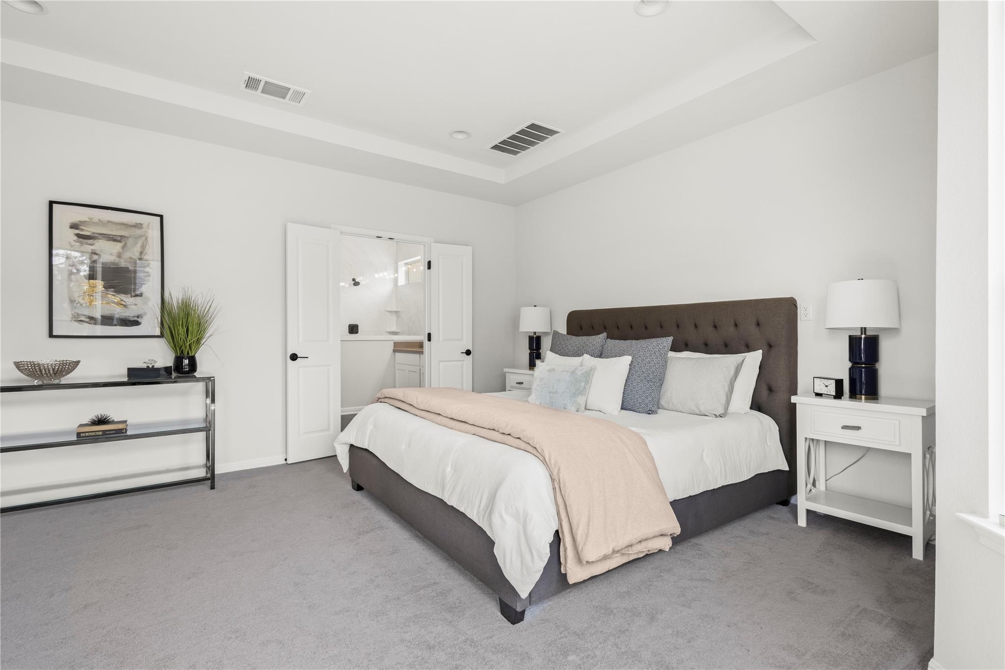 1128 Villa Rialto View Leander, TX 78641 - Photo 25 of 40 Recessed lighting and tray ceilings elevate this comfortable bedroom space.