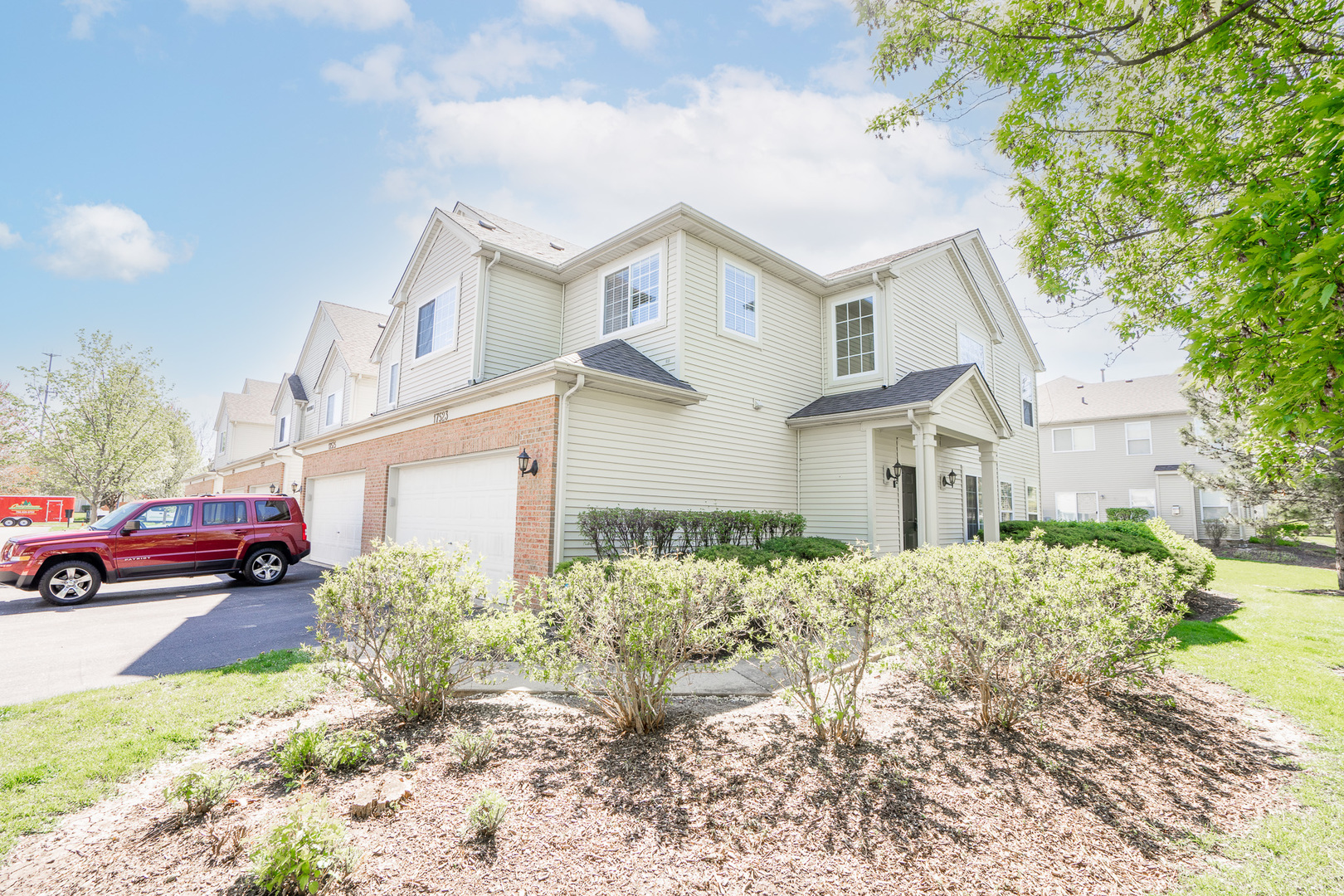 17523 Gilbert Drive Lockport, IL 60441 - Photo 1 of 34 a view of a white house next to a yard with big trees