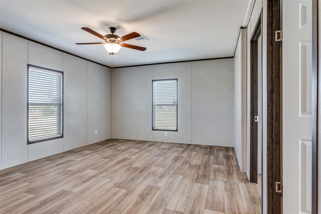 175 Cedar Drive Azle, TX 76020 - Photo 15 of 25 a view of an empty room with wooden floor and a window