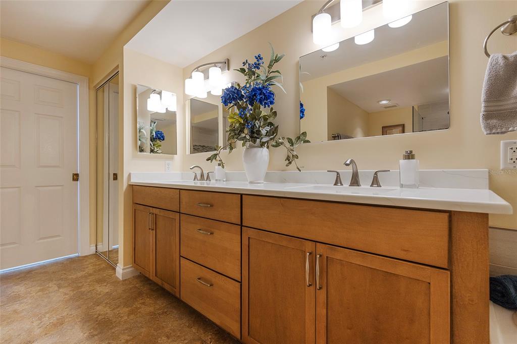 4631 South Atlantic Avenue, Unit 8601 Ponce Inlet, FL 32127 - Photo 25 of 64 a bathroom with a double vanity sink and a mirror