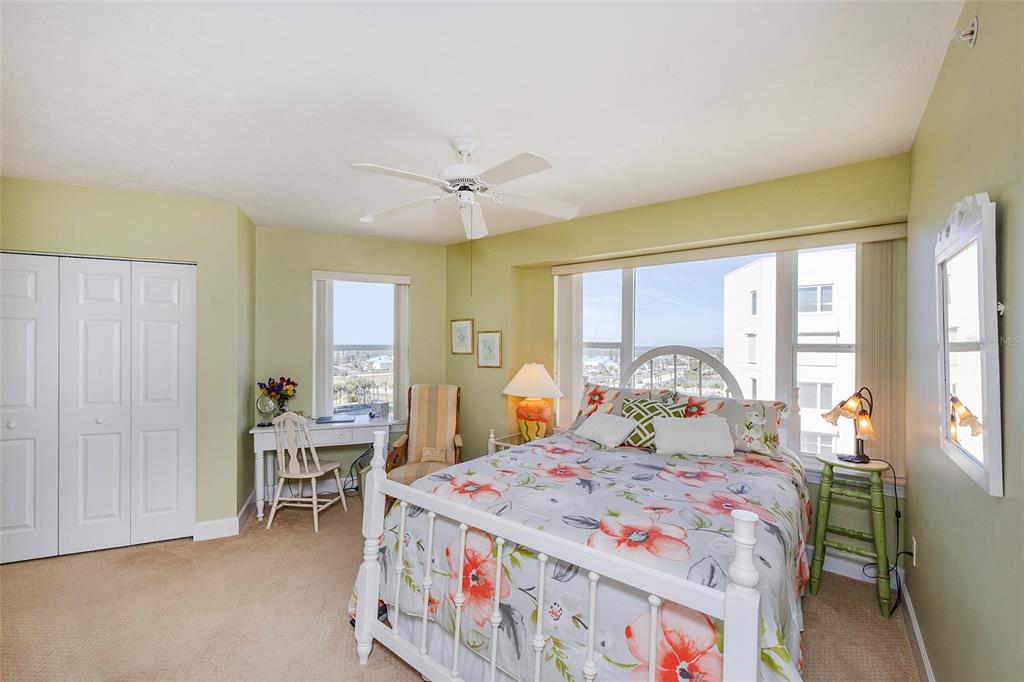 4631 South Atlantic Avenue, Unit 8601 Ponce Inlet, FL 32127 - Photo 32 of 64 a bedroom with a bed and a table in it