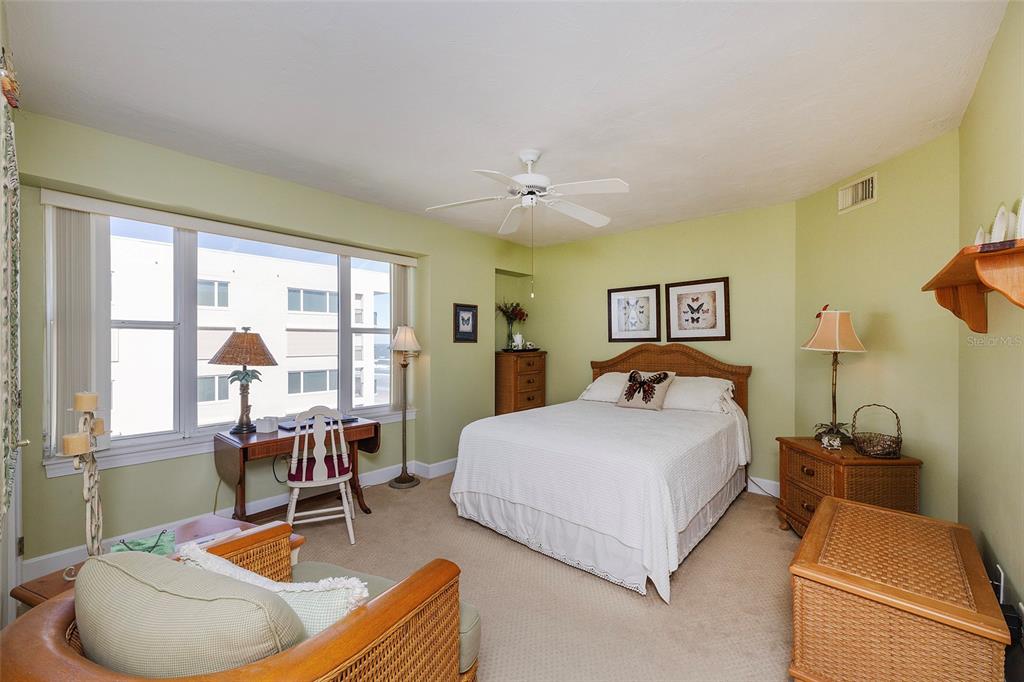 4631 South Atlantic Avenue, Unit 8601 Ponce Inlet, FL 32127 - Photo 34 of 64 a bed room with a bed and a chair