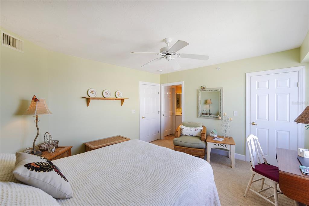 4631 South Atlantic Avenue, Unit 8601 Ponce Inlet, FL 32127 - Photo 36 of 64 a bedroom with a bed and a chandelier