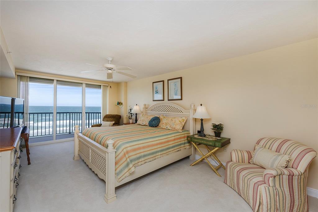 4631 South Atlantic Avenue, Unit 8601 Ponce Inlet, FL 32127 - Photo 37 of 64 a bedroom with a bed and a couch