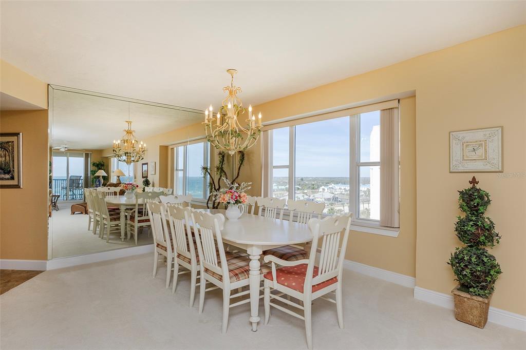 4631 South Atlantic Avenue, Unit 8601 Ponce Inlet, FL 32127 - Photo 41 of 64 a view of a dining room with furniture window and chandelier