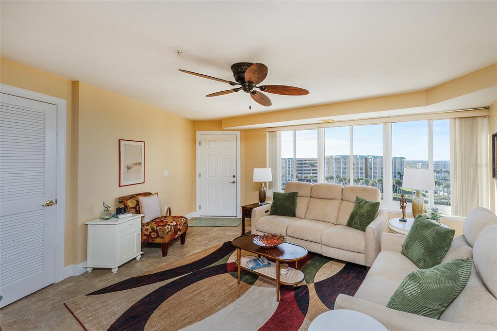 4631 South Atlantic Avenue, Unit 8601 Ponce Inlet, FL 32127 - Photo 45 of 64 a living room with furniture and a large window