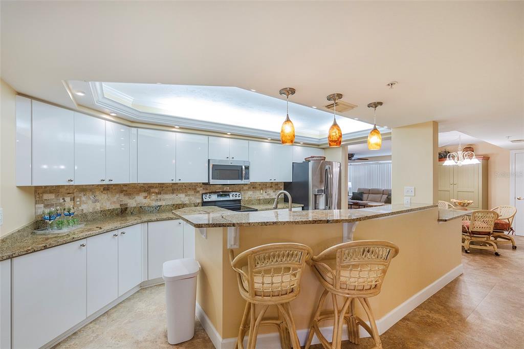 4631 South Atlantic Avenue, Unit 8601 Ponce Inlet, FL 32127 - Photo 46 of 64 a kitchen with stainless steel appliances granite countertop a sink and cabinets