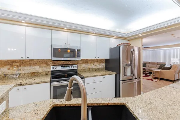 a view of a dining room with furniture and chandelier