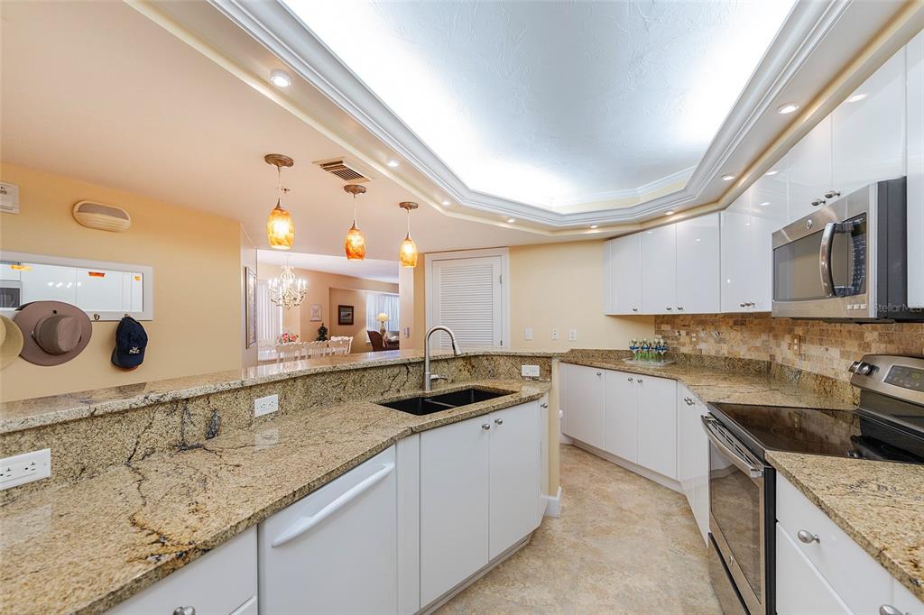 4631 South Atlantic Avenue, Unit 8601 Ponce Inlet, FL 32127 - Photo 49 of 64 a kitchen with a sink stove and microwave
