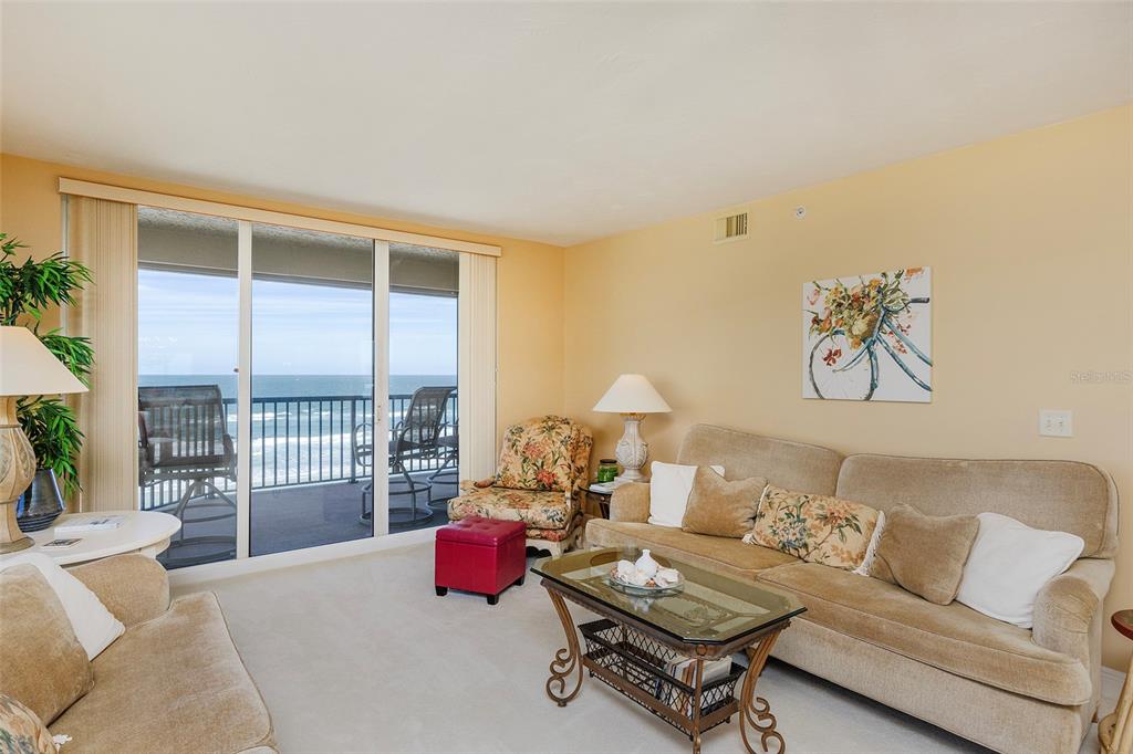 4631 South Atlantic Avenue, Unit 8601 Ponce Inlet, FL 32127 - Photo 59 of 64 a living room with furniture and a floor to ceiling window