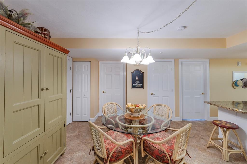 4631 South Atlantic Avenue, Unit 8601 Ponce Inlet, FL 32127 - Photo 61 of 64 a view of a dining room with furniture and chandelier