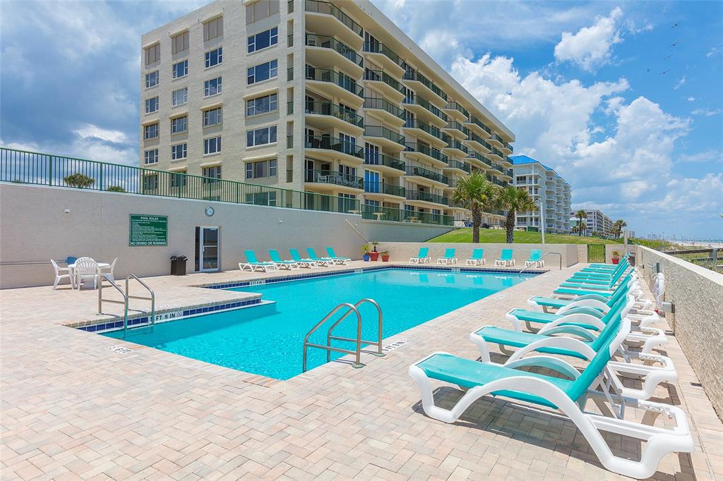 4631 South Atlantic Avenue, Unit 8601 Ponce Inlet, FL 32127 - Photo 63 of 64 a view of a swimming pool with a lounge chairs