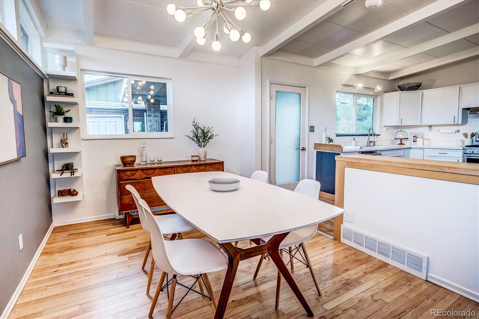 4615 Gordon Drive Boulder, CO 80305 - Photo 12 of 27 a dining room with wooden floor and chandelier