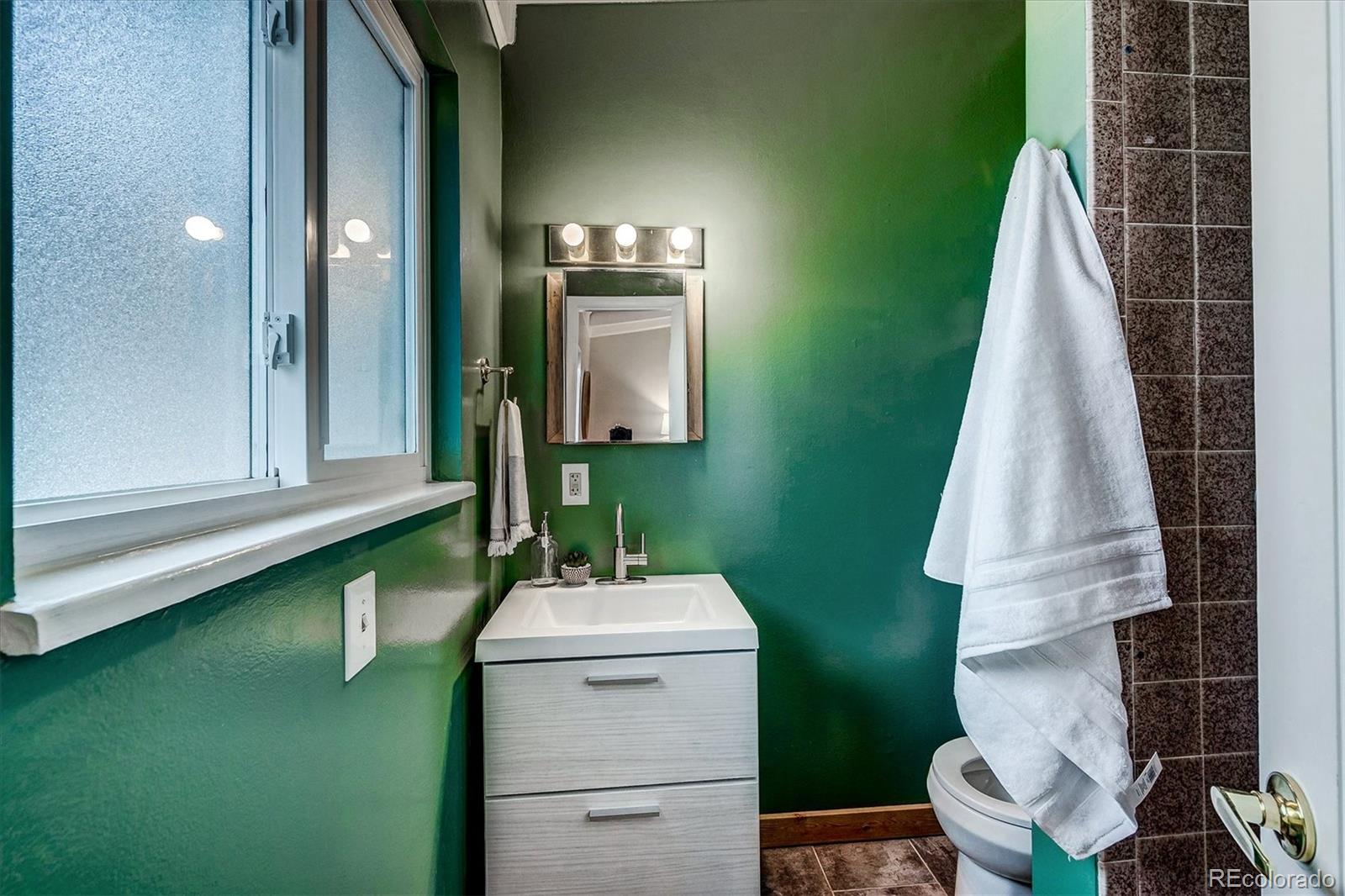 4615 Gordon Drive Boulder, CO 80305 - Photo 16 of 27 a bathroom with a sink and mirror with bathtub