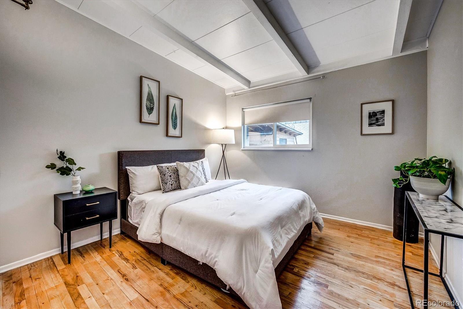 4615 Gordon Drive Boulder, CO 80305 - Photo 17 of 27 a bedroom with a bed and wooden floor