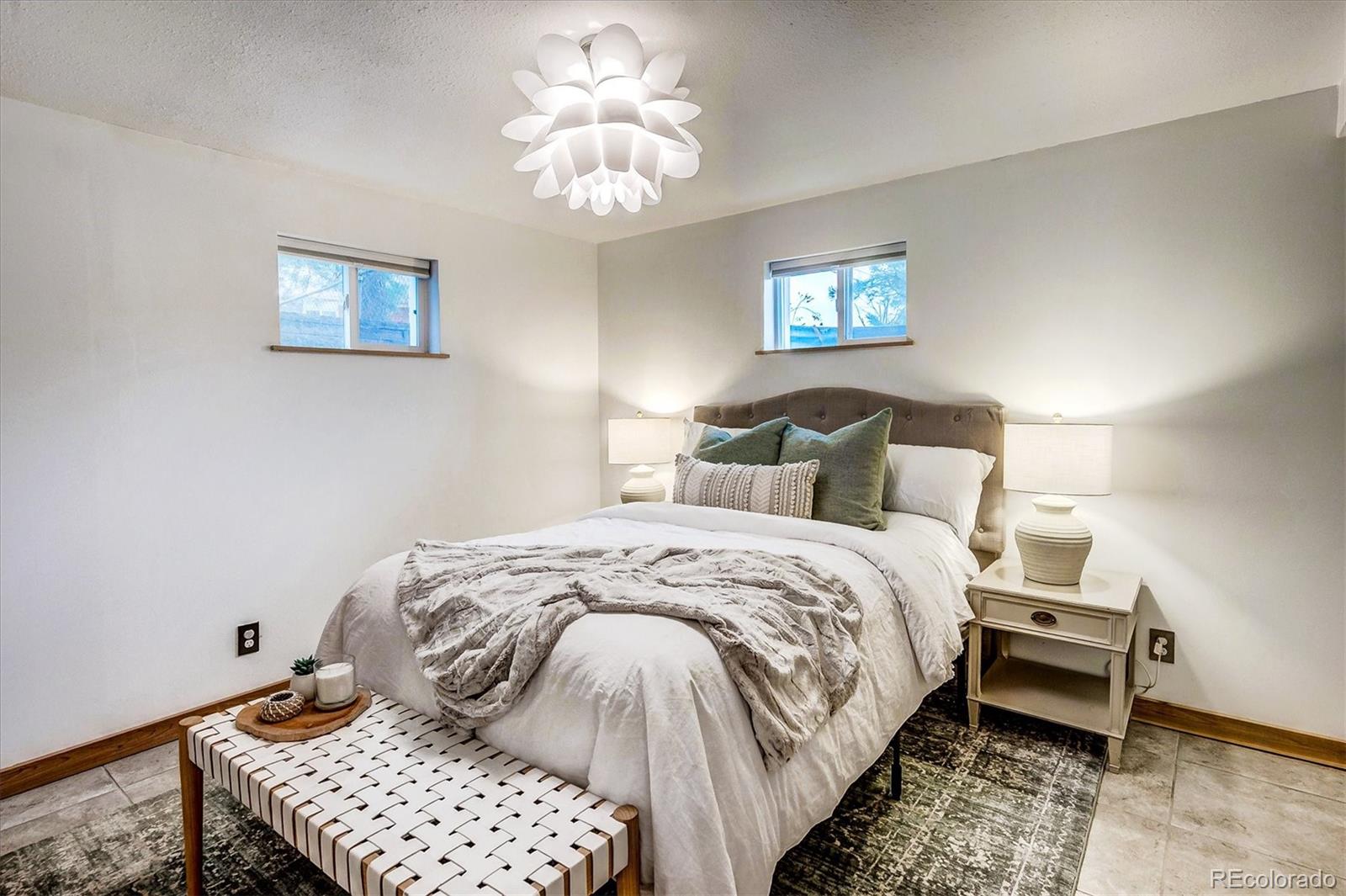 4615 Gordon Drive Boulder, CO 80305 - Photo 22 of 27 a bedroom with a bed and a chandelier