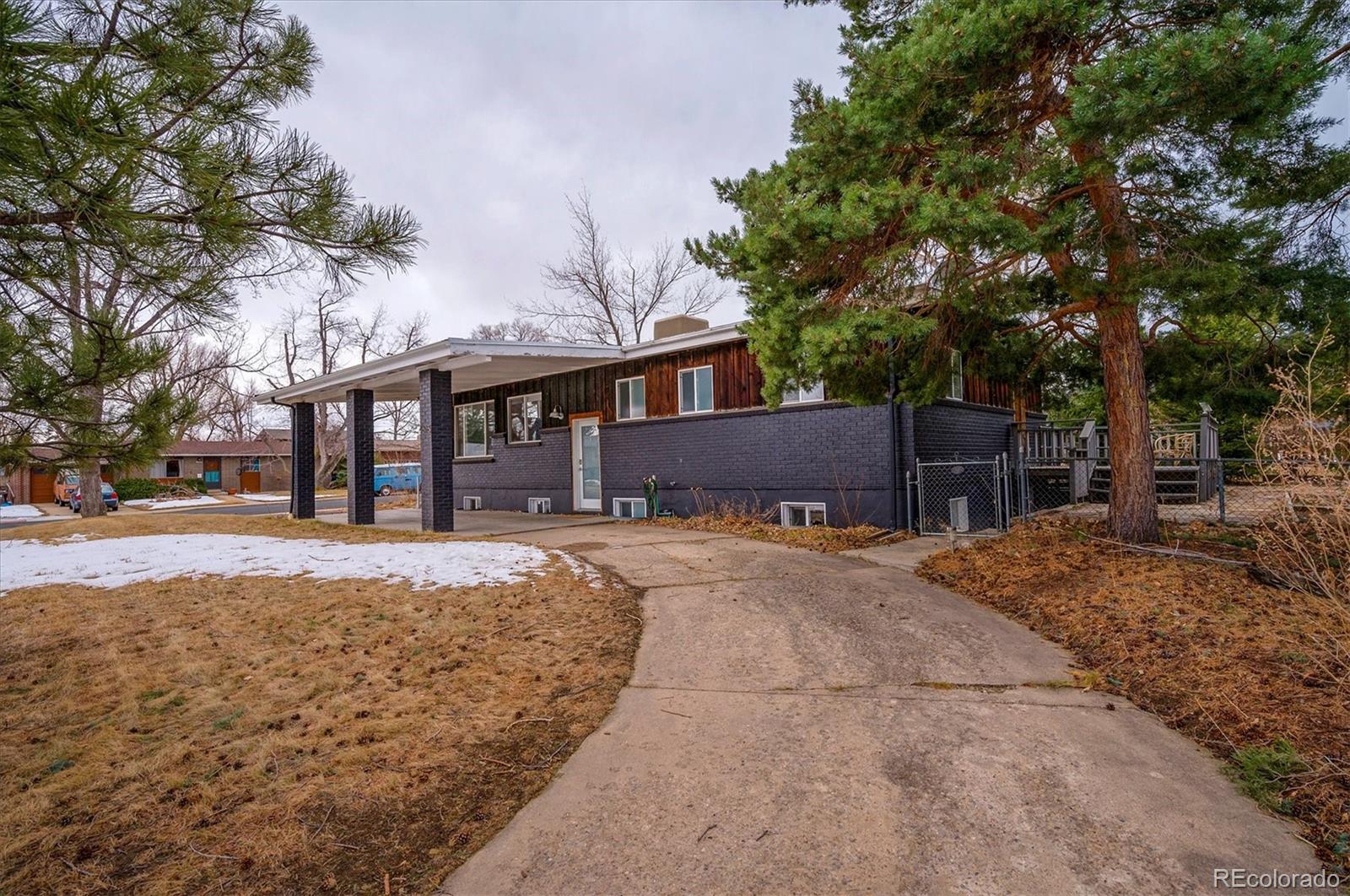 4615 Gordon Drive Boulder, CO 80305 - Photo 3 of 27 a front view of a house with a yard and garage