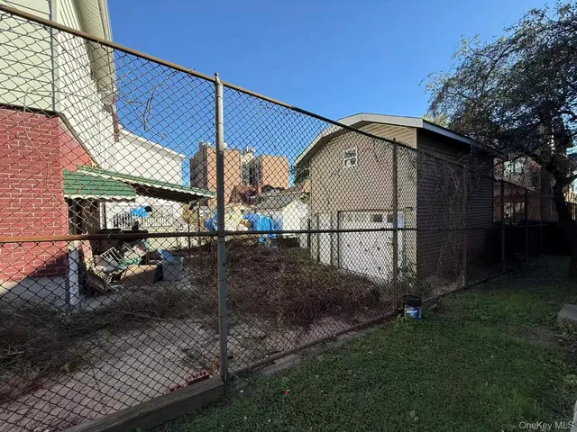 a view of a house with a wooden fence