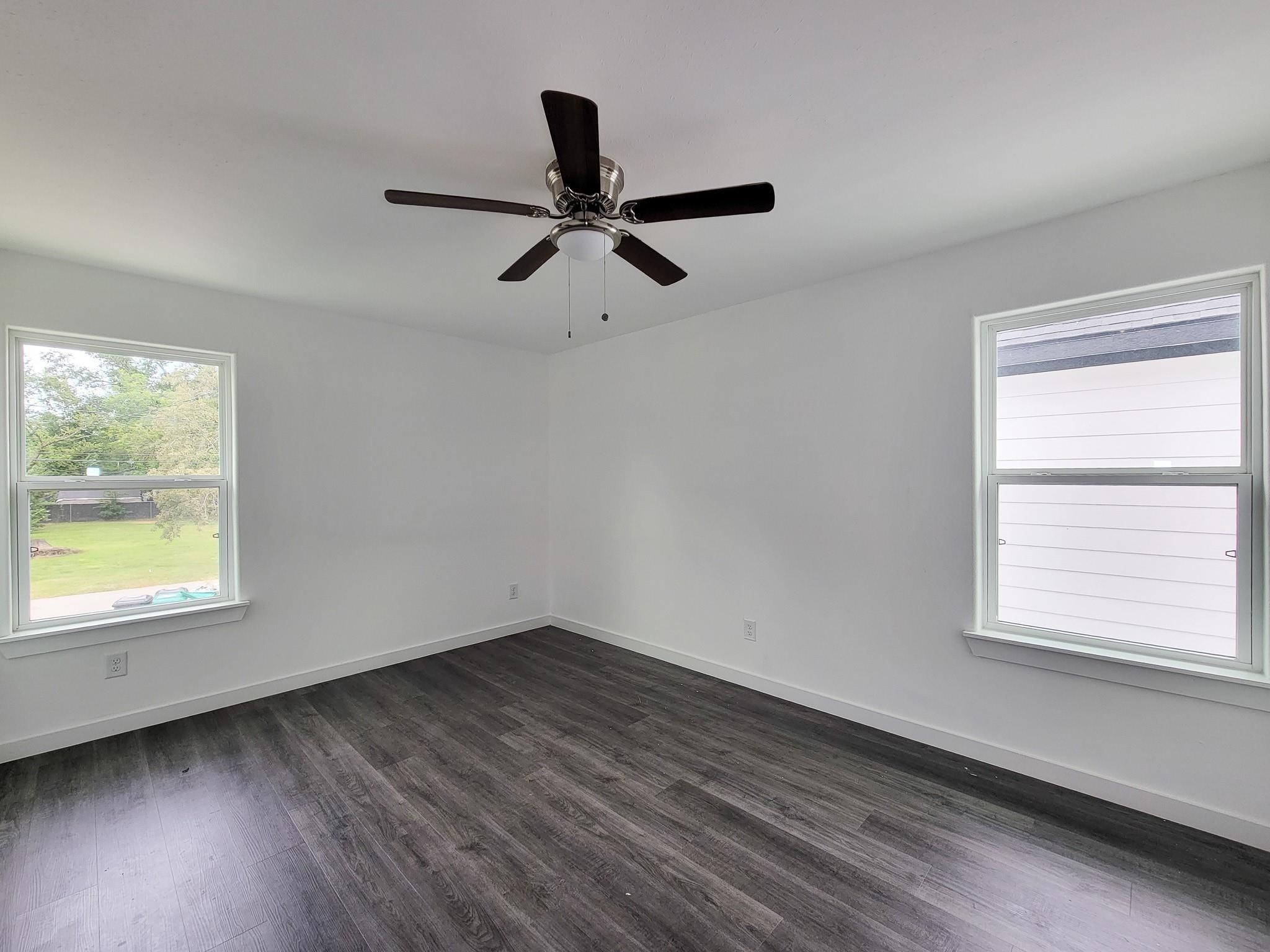 8122 Sterlingshire Street, Unit B Houston, TX 77078 - Photo 11 of 24 wooden floor in an empty room with a window