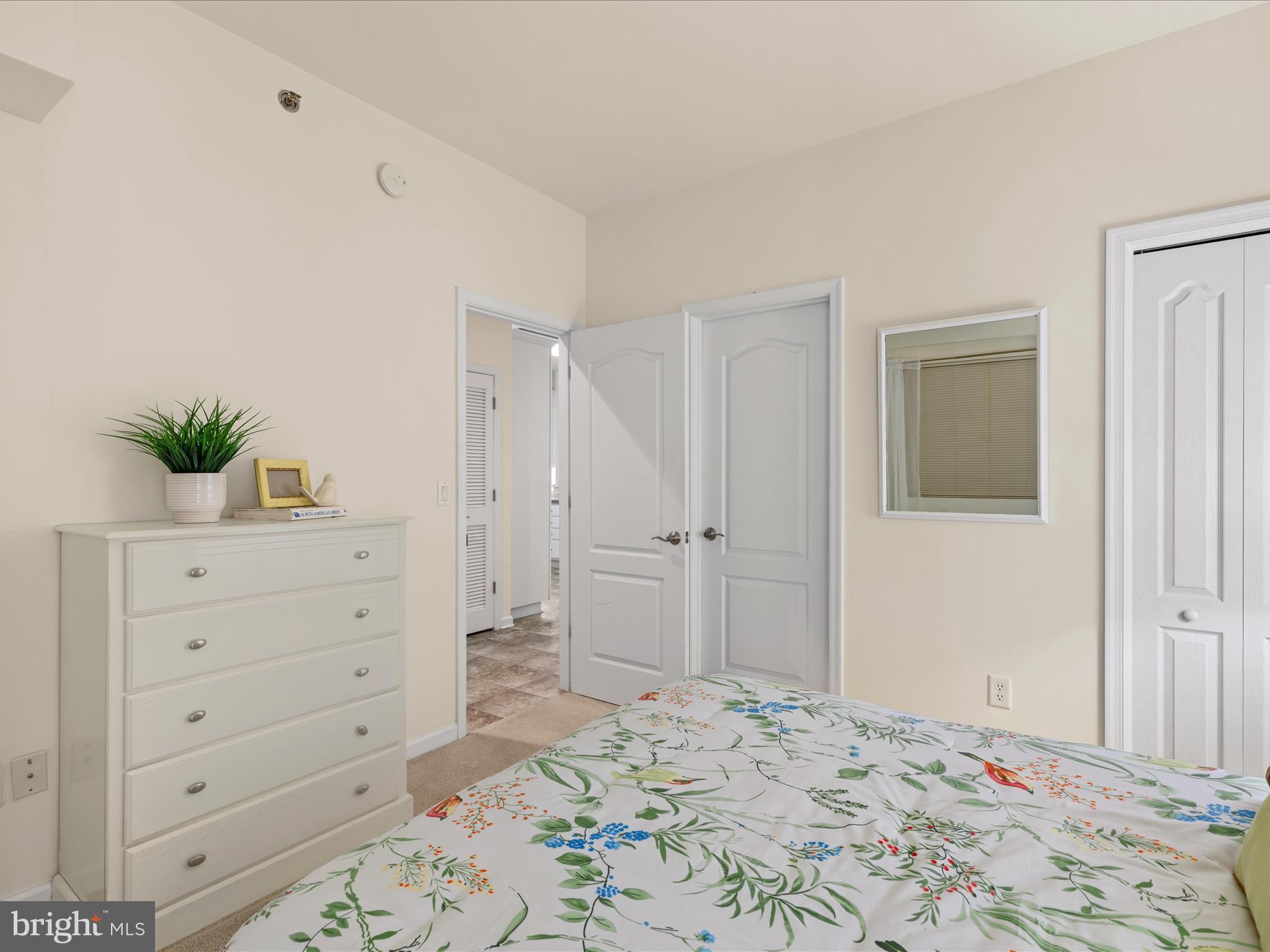 30413 Cedar Neck Road, Unit 304 Ocean View, DE 19970 - Photo 25 of 46 a bedroom with a bed and a dresser in it