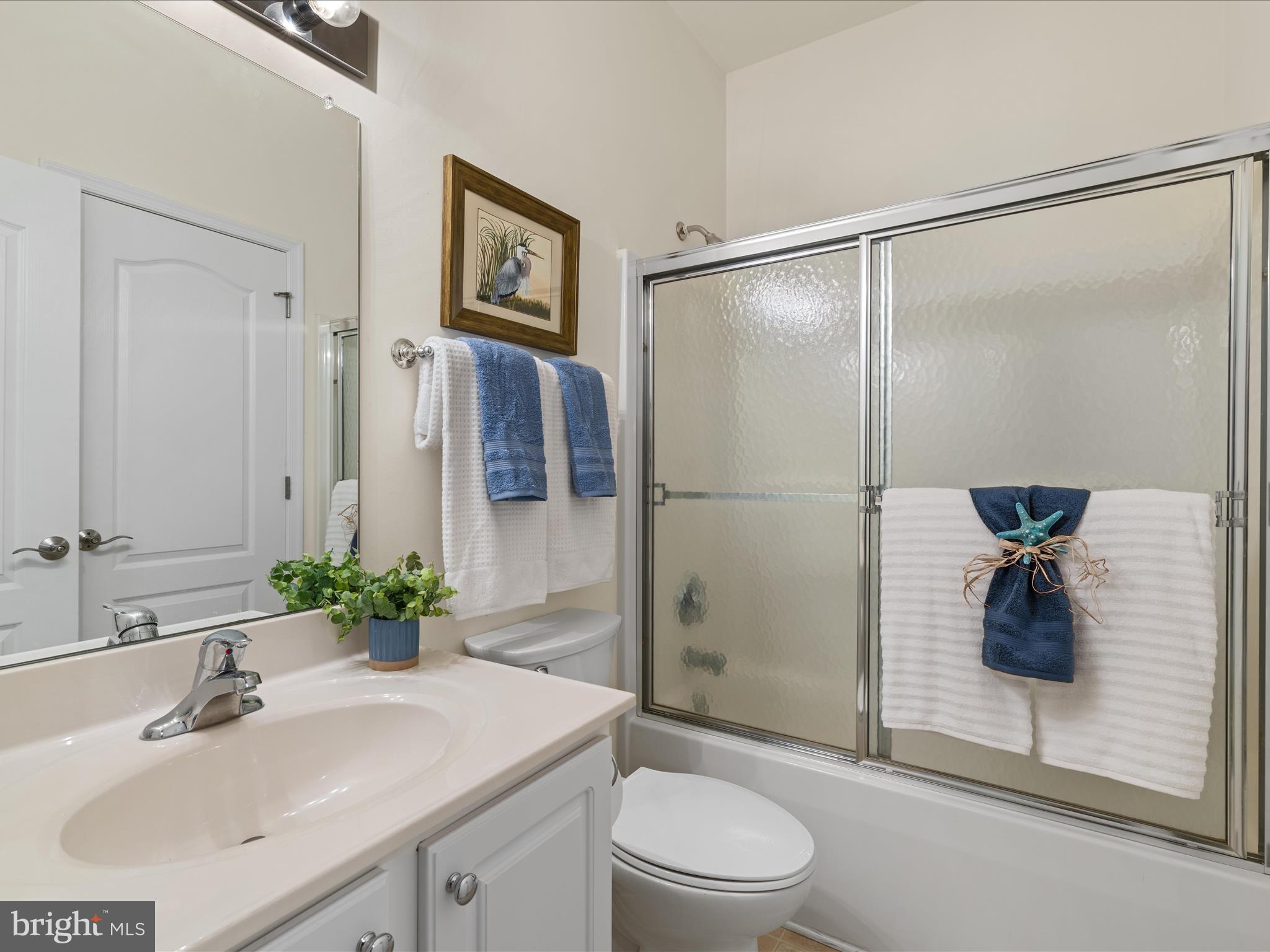 30413 Cedar Neck Road, Unit 304 Ocean View, DE 19970 - Photo 26 of 46 a bathroom with a sink toilet and shower