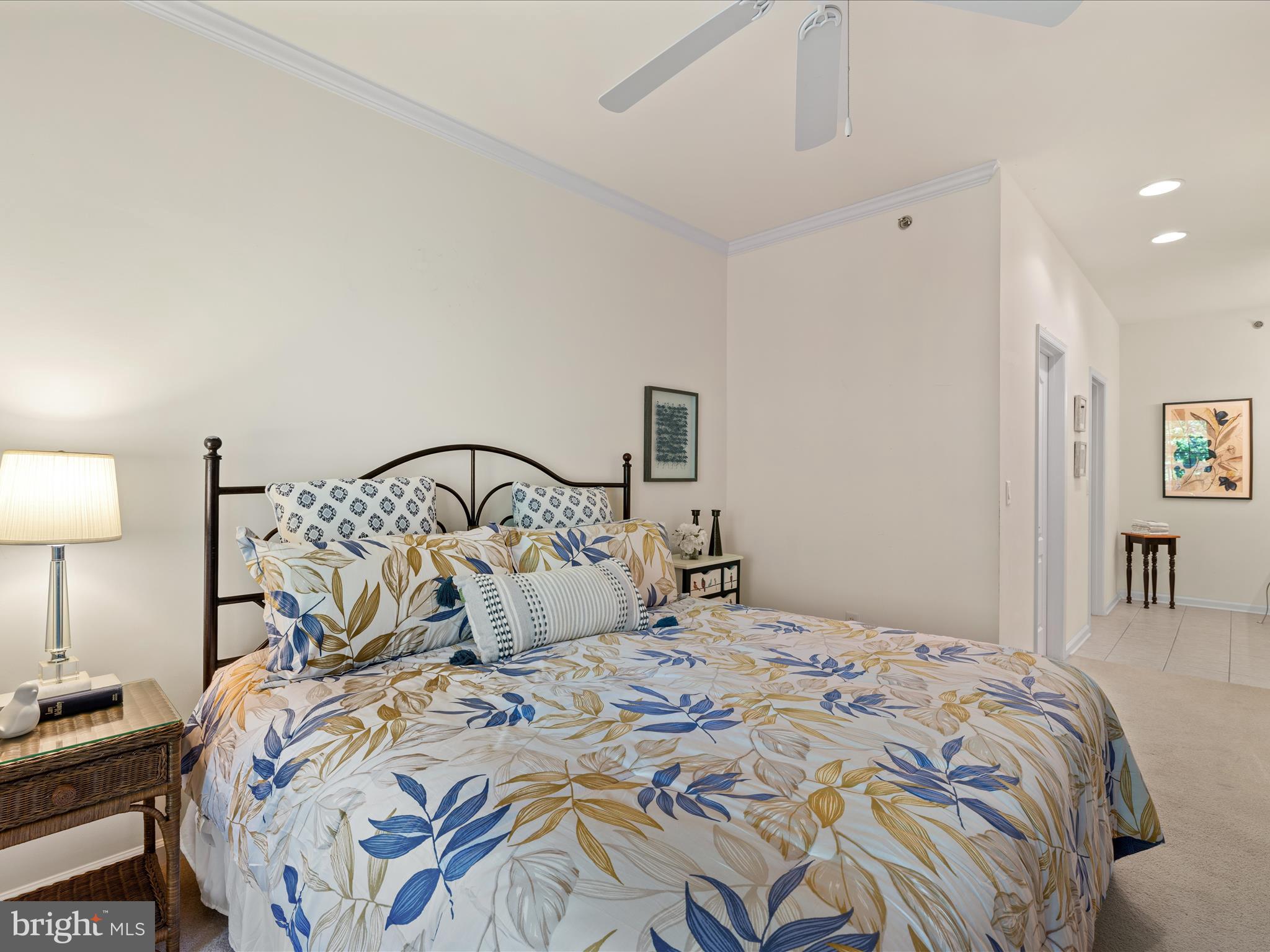 30413 Cedar Neck Road, Unit 304 Ocean View, DE 19970 - Photo 29 of 46 a bedroom with a bed and a lamp