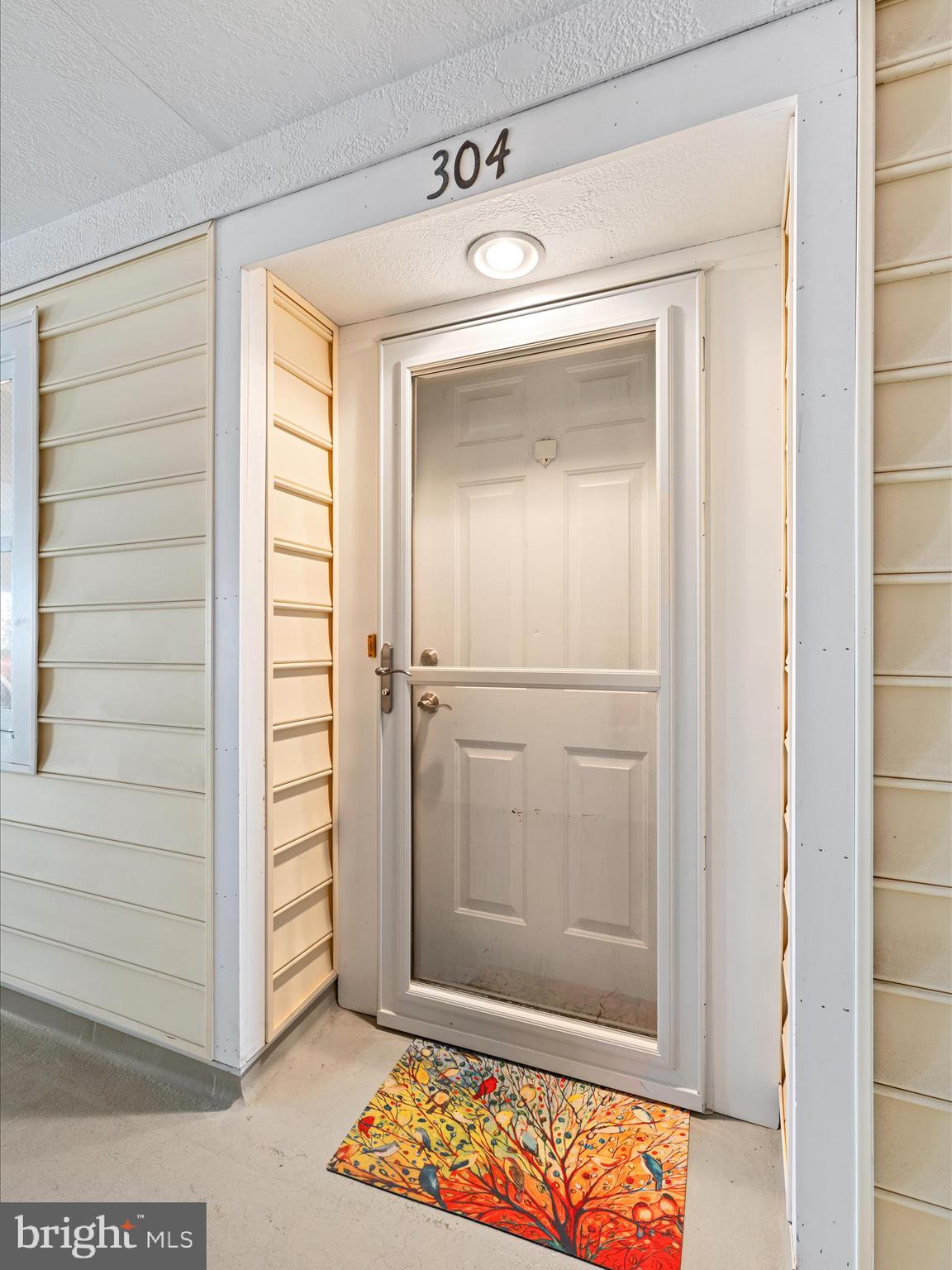 30413 Cedar Neck Road, Unit 304 Ocean View, DE 19970 - Photo 3 of 46 a view of front door with hallway