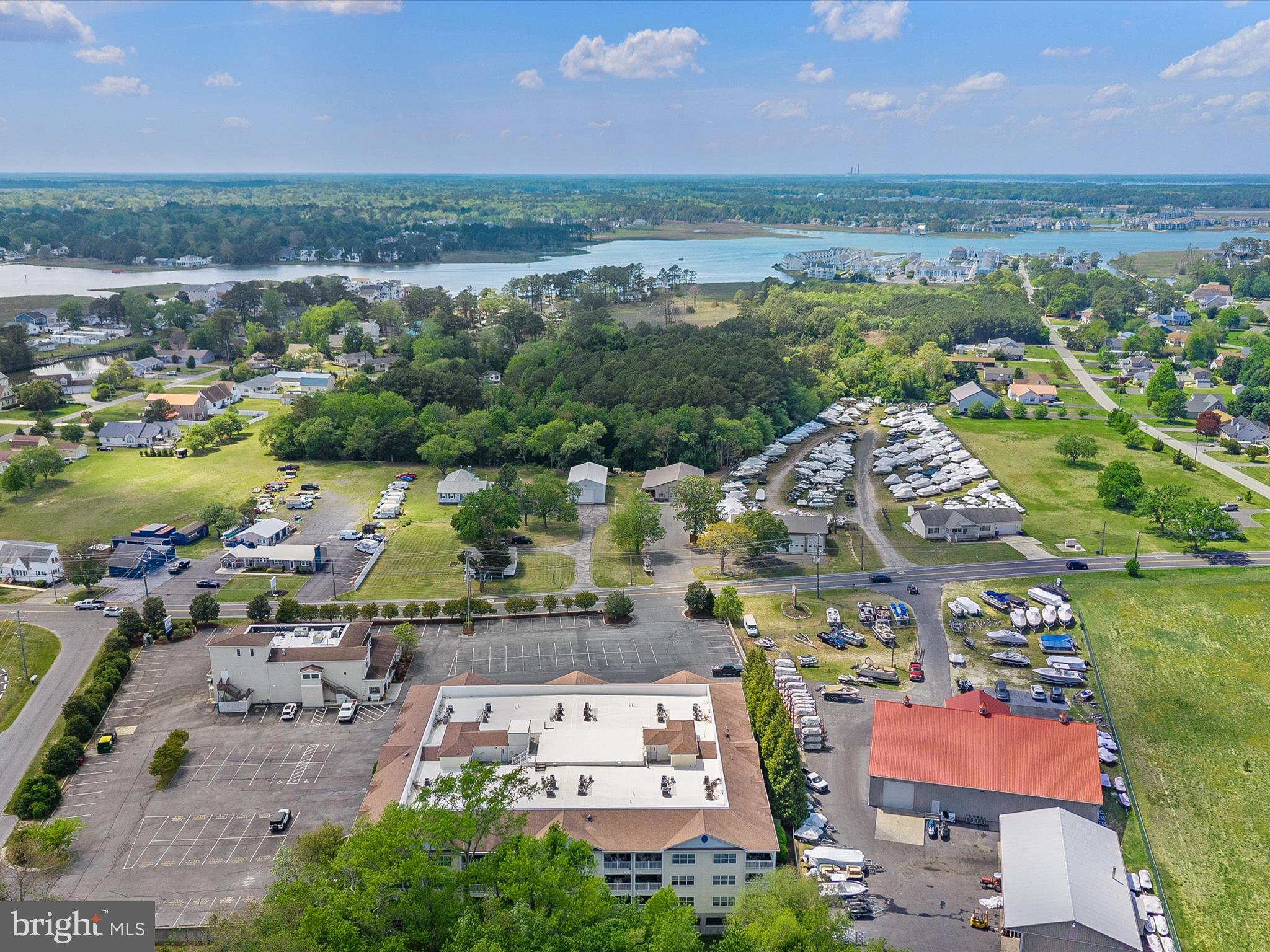 30413 Cedar Neck Road, Unit 304 Ocean View, DE 19970 - Photo 40 of 46 an aerial view of residential building and lake