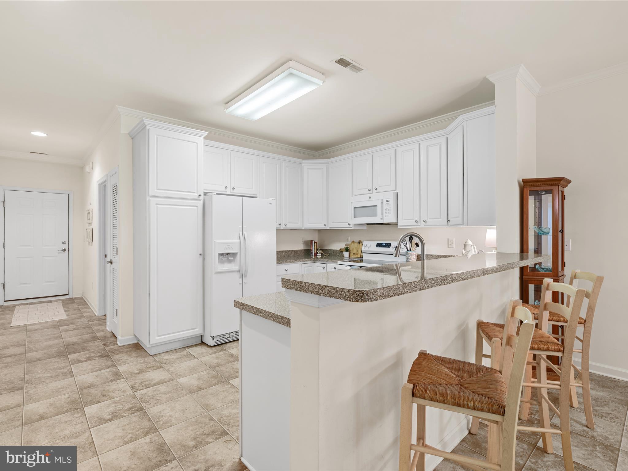 30413 Cedar Neck Road, Unit 304 Ocean View, DE 19970 - Photo 7 of 46 a kitchen with stainless steel appliances granite countertop a sink and cabinets