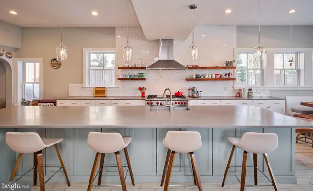 a large white kitchen with a large window