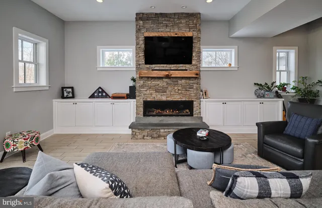 a living room with a fireplace and a fireplace