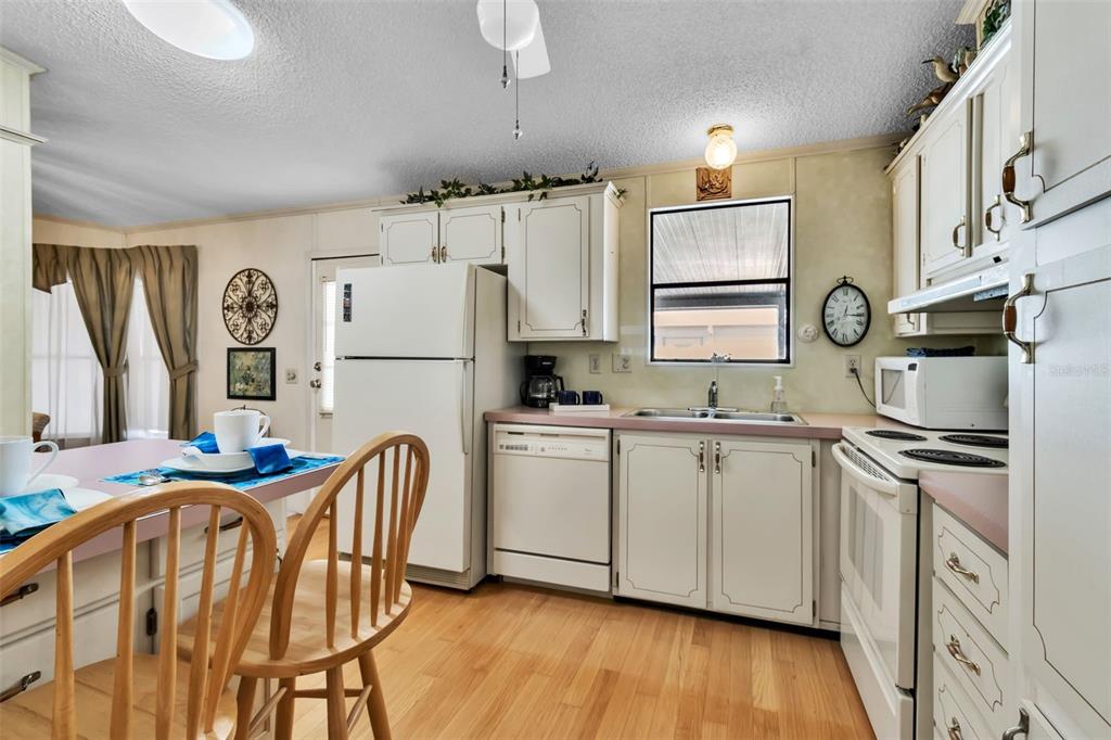 10315 Cortez Road West, Unit 26J Bradenton, FL 34210 - Photo 14 of 69 a kitchen with stainless steel appliances granite countertop a white cabinets and a refrigerator