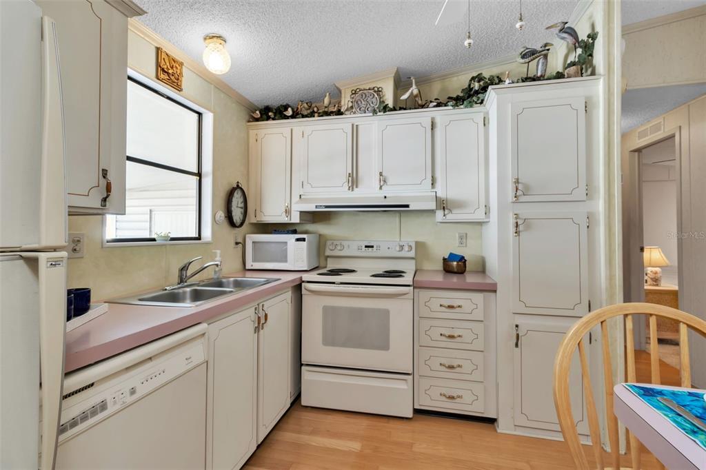 10315 Cortez Road West, Unit 26J Bradenton, FL 34210 - Photo 15 of 69 a kitchen with cabinets appliances a sink and a window