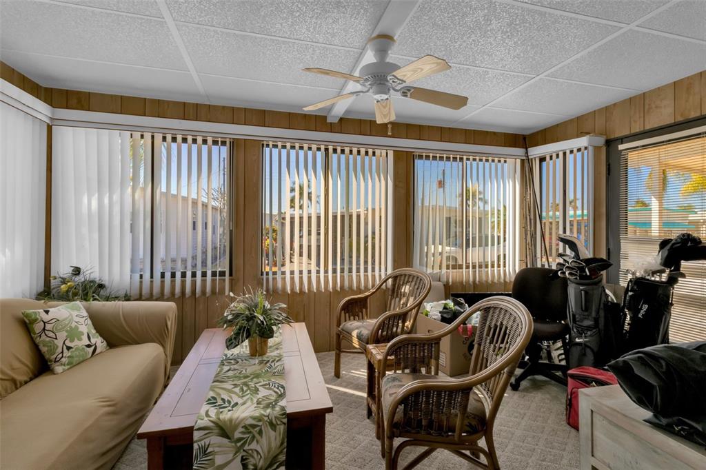 10315 Cortez Road West, Unit 26J Bradenton, FL 34210 - Photo 24 of 69 a living room with furniture and floor to ceiling windows