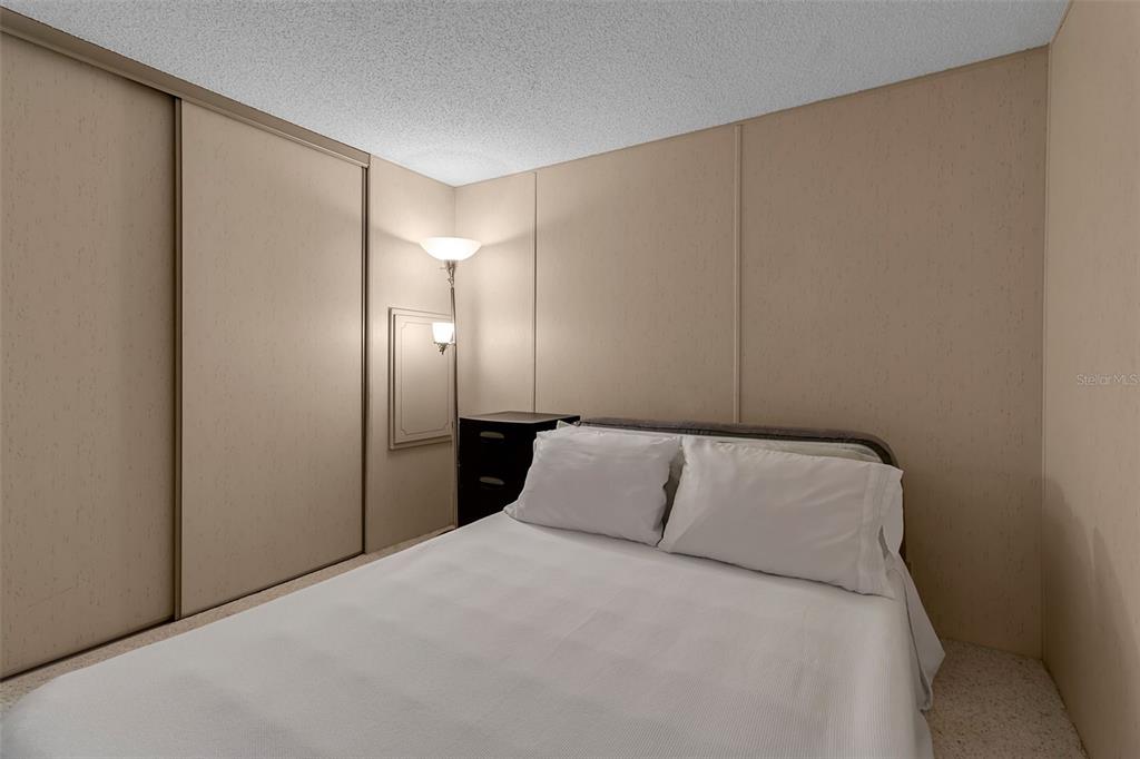 10315 Cortez Road West, Unit 26J Bradenton, FL 34210 - Photo 26 of 69 a bedroom with a bed and a night stand