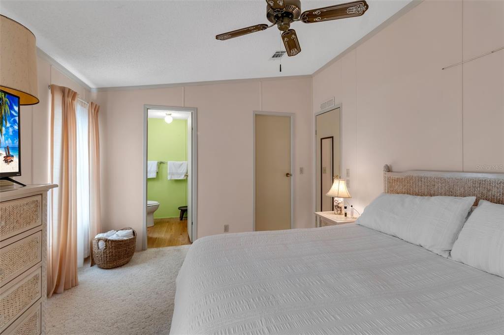 10315 Cortez Road West, Unit 26J Bradenton, FL 34210 - Photo 30 of 69 a bedroom with a bed and a chandelier